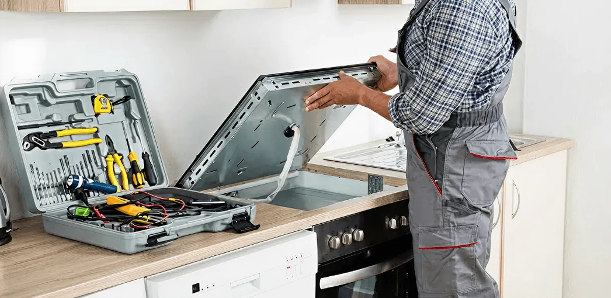 Handyman repairing a cooktop and checking wiring connections in Portland, OR