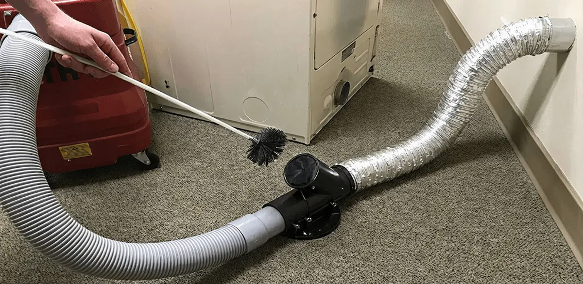 Dryer vent cleaning service removing lint from a dryer duct connection in Portland, OR